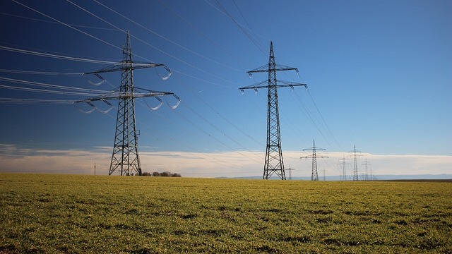 Utility poles and cables in suburban setting representing broadband pole attachment ruling
