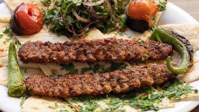 Mediterranean plate with rice, meat, and salad in a San Antonio restaurant.
