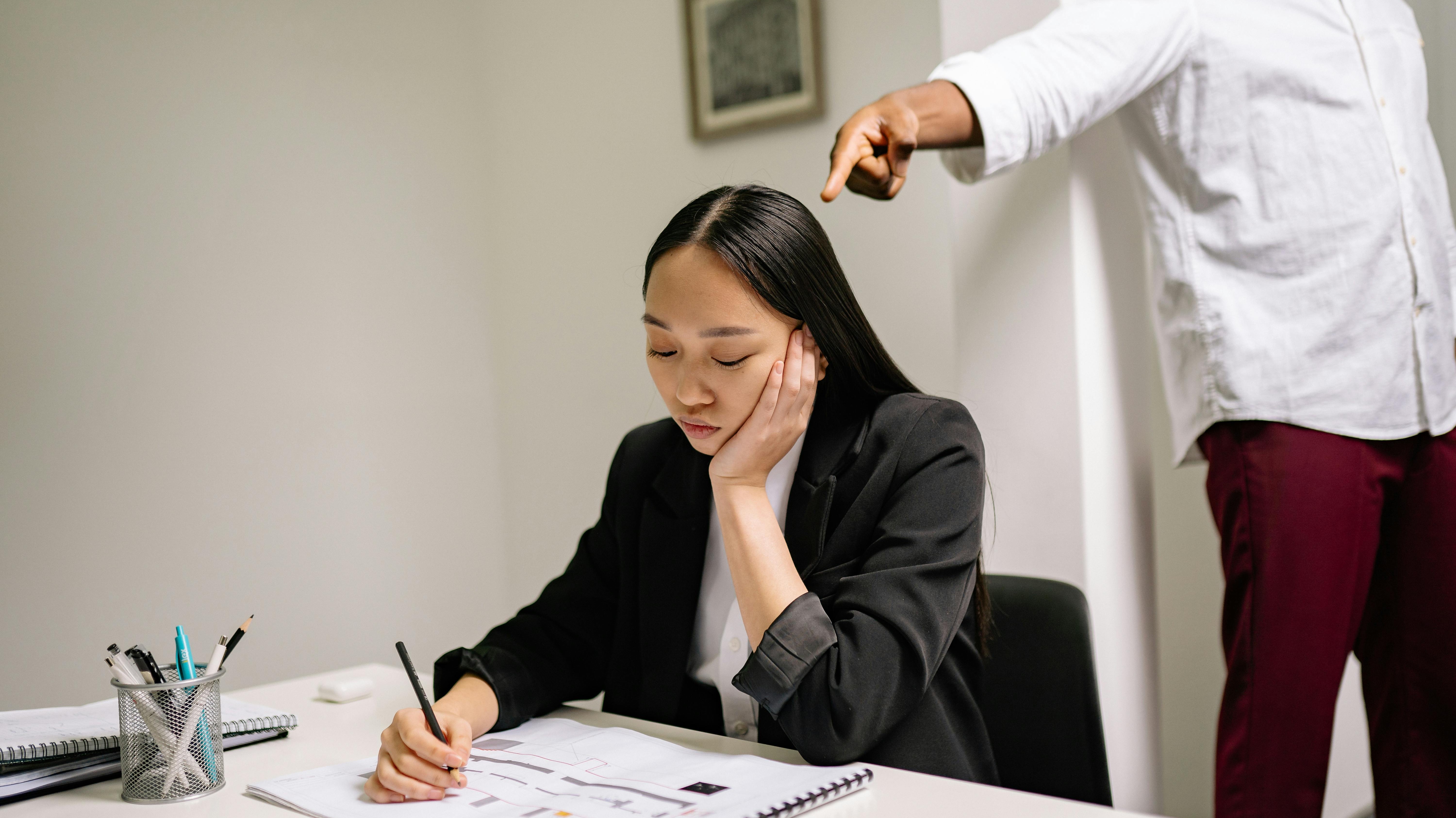 Middle-aged man stressed in bullying workplace situation.