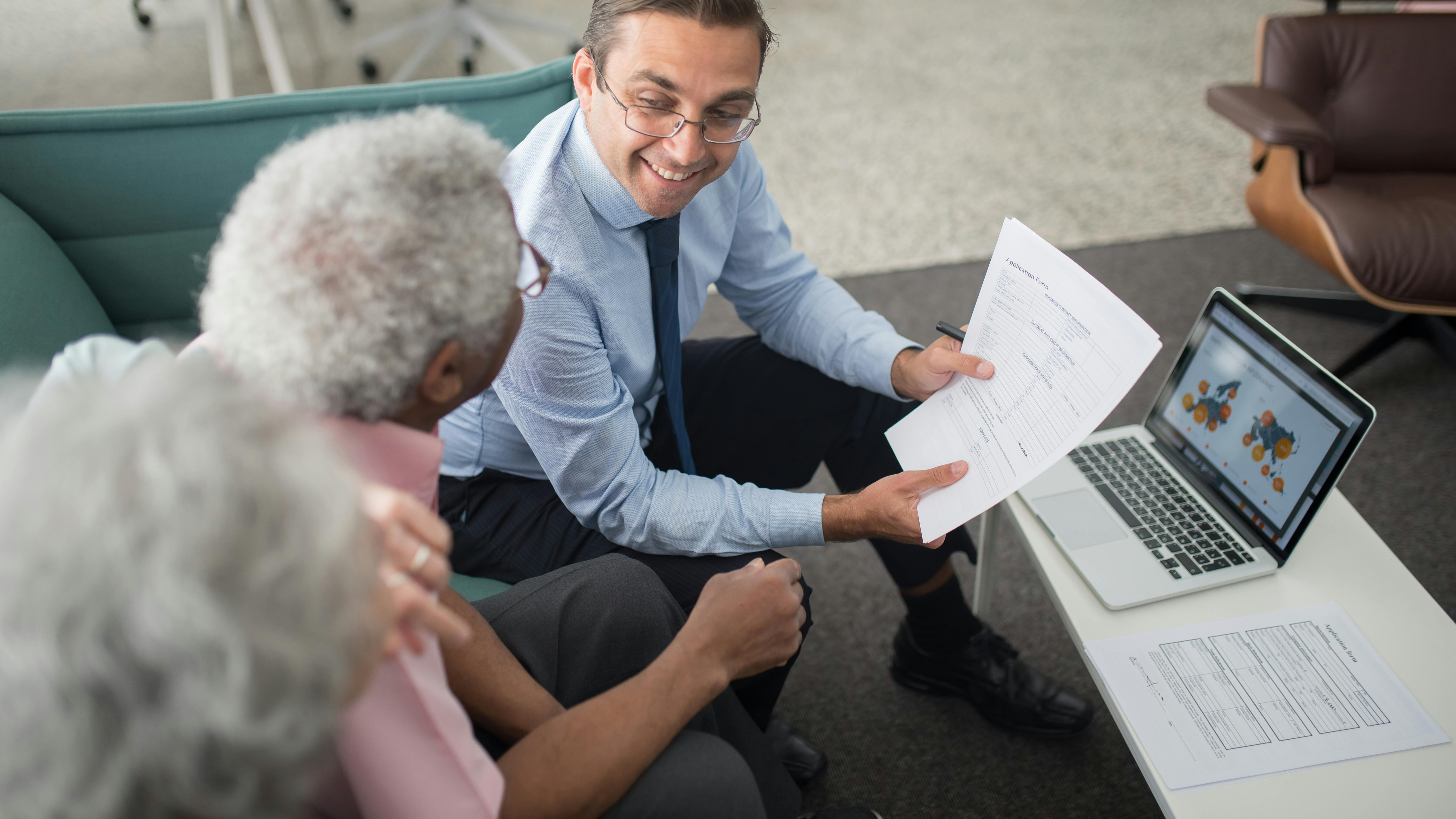 Elderly couple planning philanthropic retirement in San Antonio with advisor.