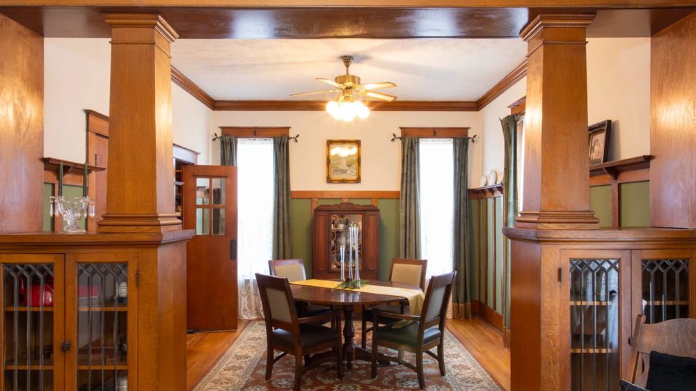 Historic house built for magic in Omaha with lush greenery, sunny day.