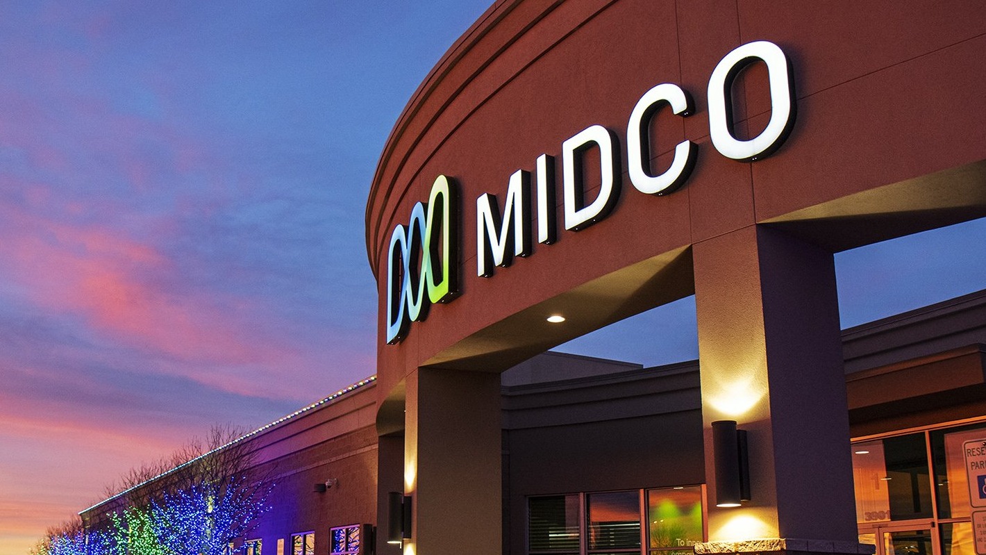 Midco logo design with blue and green waves.