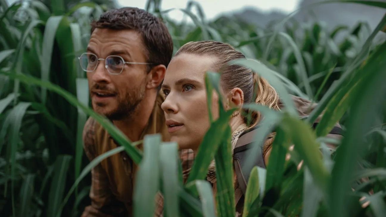 Jurassic World Rebirth review scene showing protective-suited observer with dinosaur