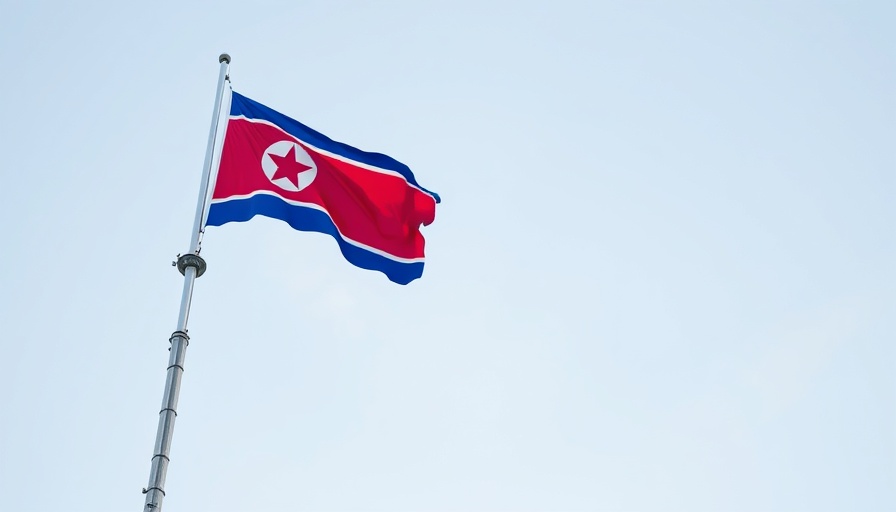 North Korean flag atop a tall tower against clear sky.