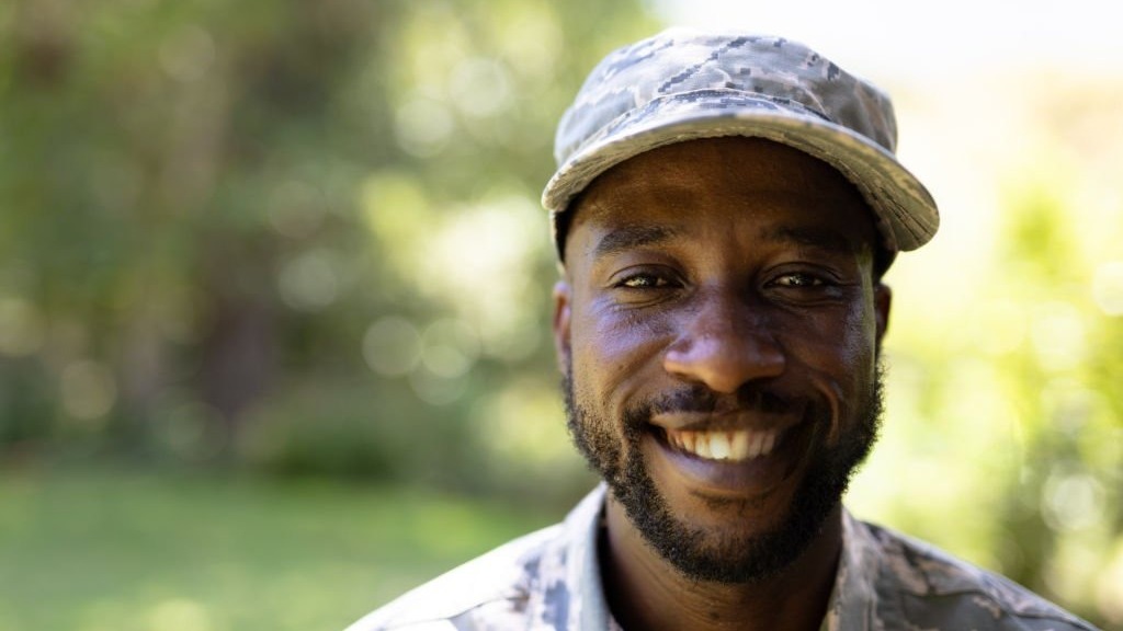 Young man in military gear confidently shares bravery stories
