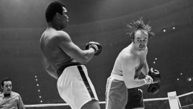 Historic boxing match with intense focus and dramatic motion.