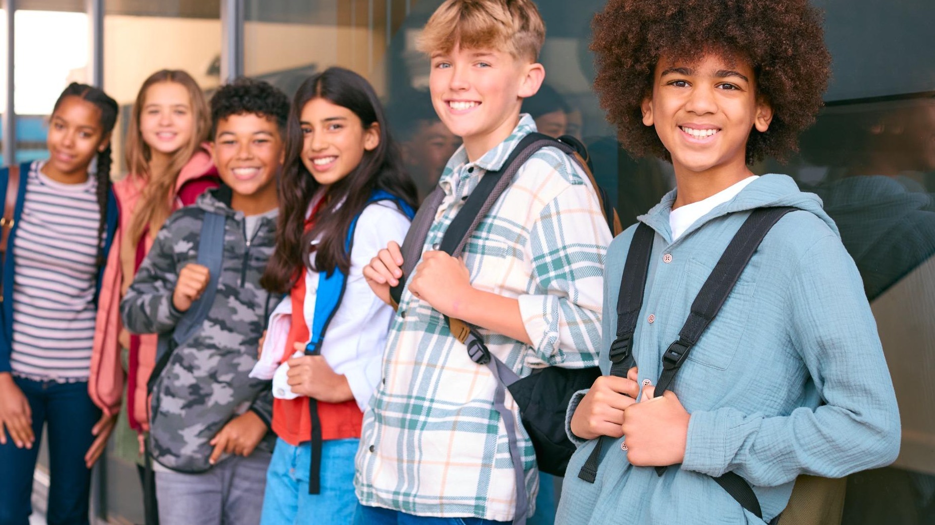 Middle school students in class and teacher at front demonstrate BIG changes.