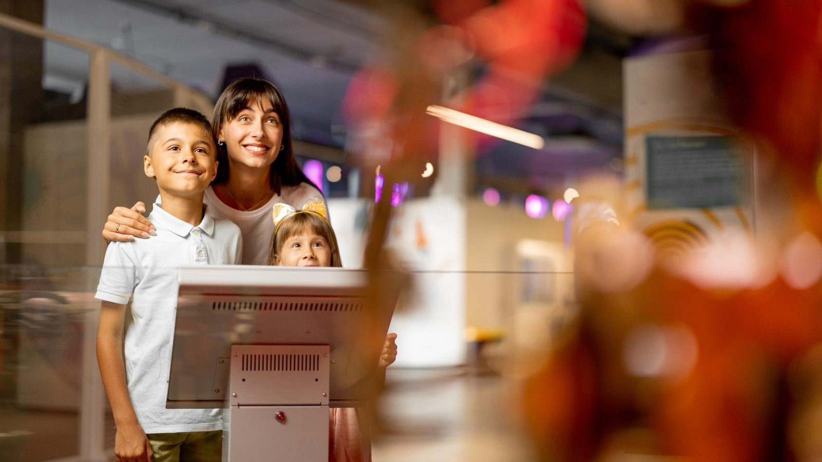 Family explores museum exhibit in San Antonio, kid-friendly event.