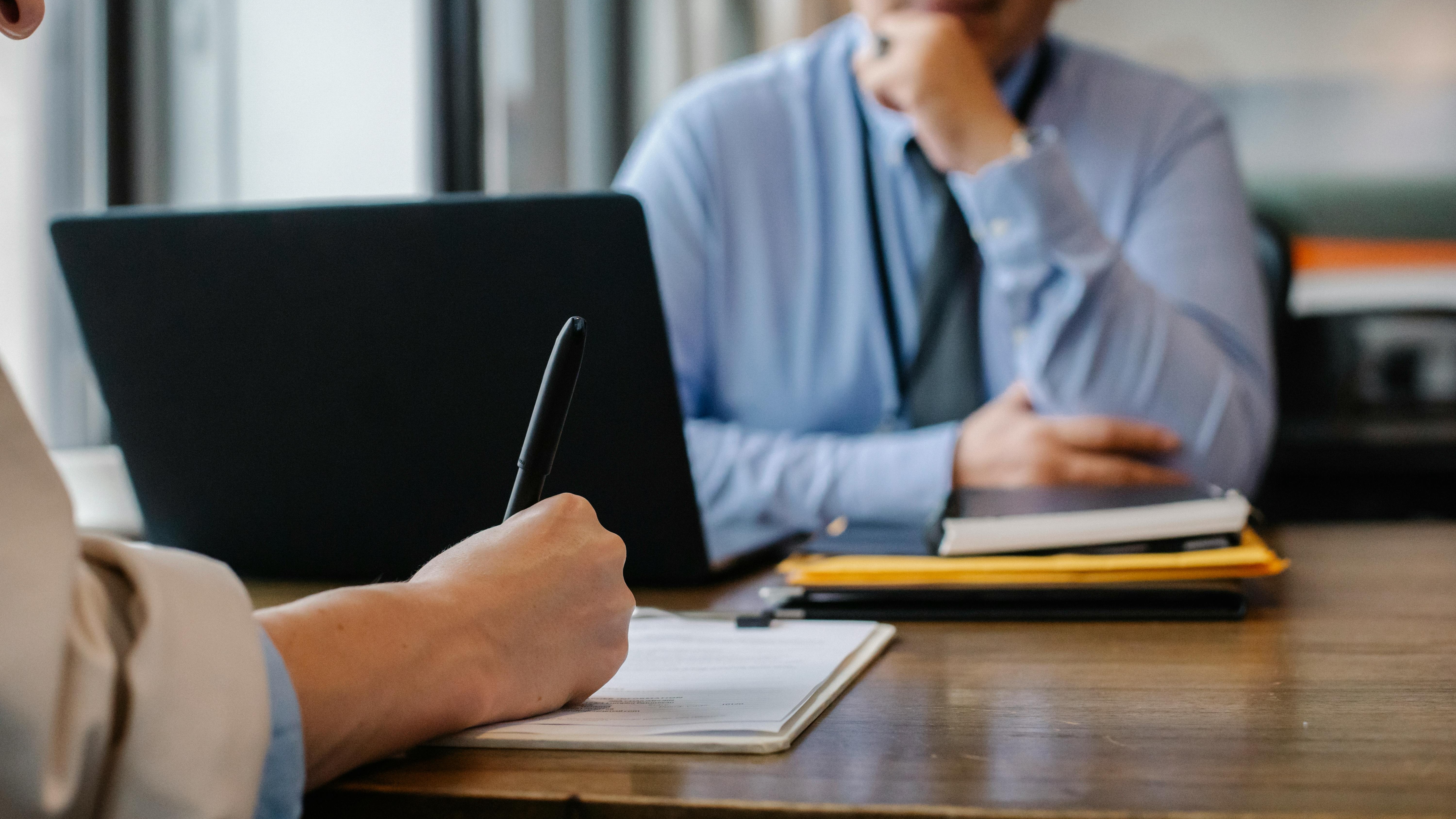 Professionals discussing high-performance culture recruitment strategy in an office.