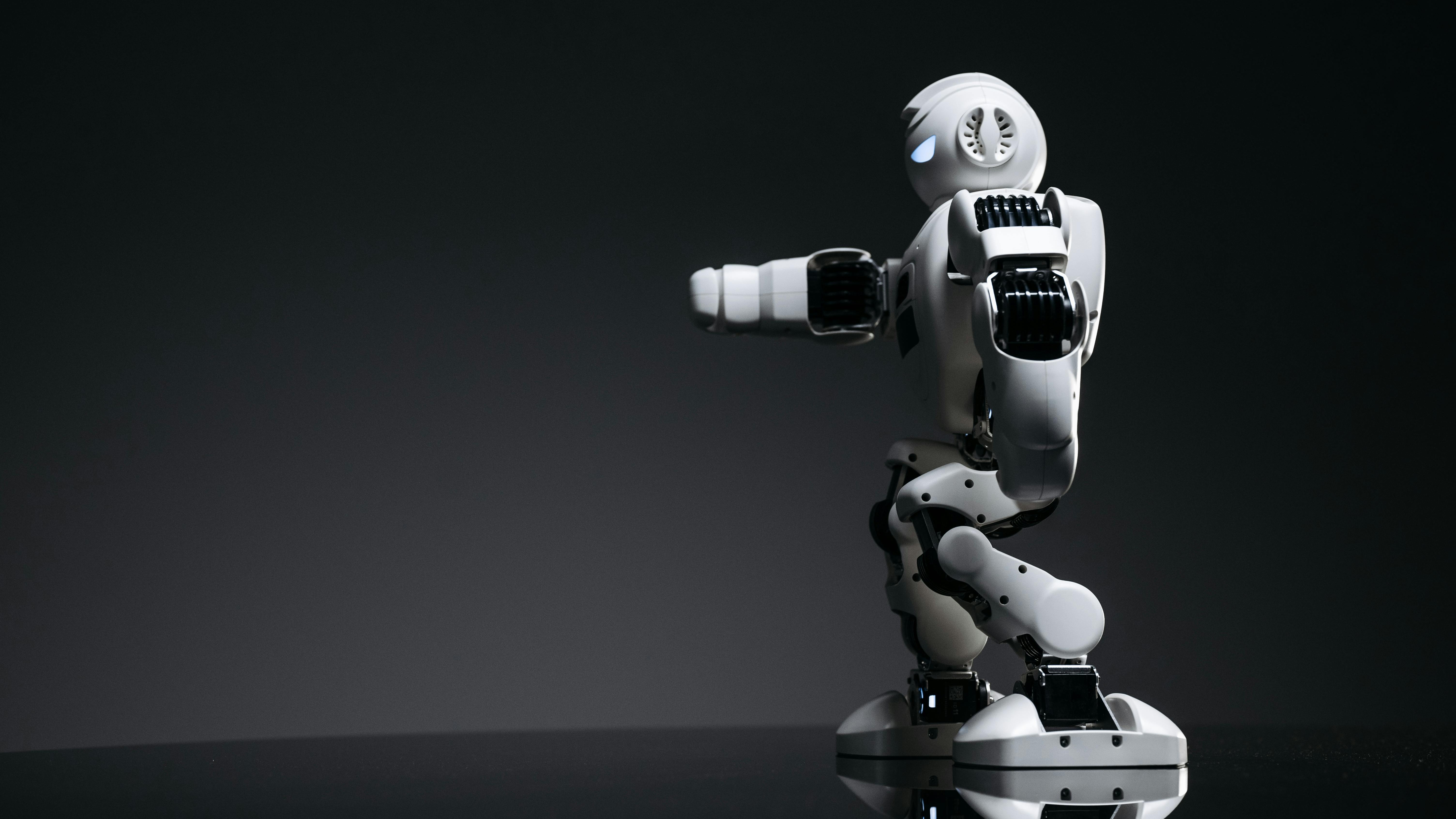 AI impact on job market for graduates - woman and robot in futuristic office.