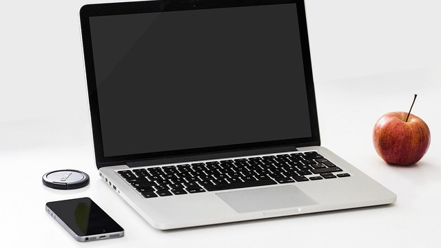 Sleek partially open MacBook glowing softly at M5 launch.