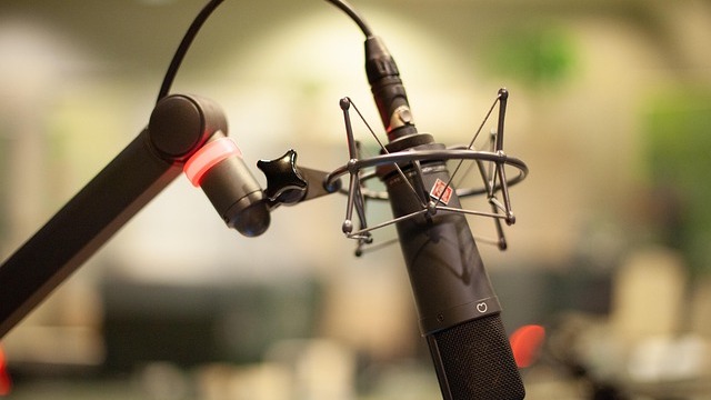 Radio host in studio indicative of Texas public radio funding crisis