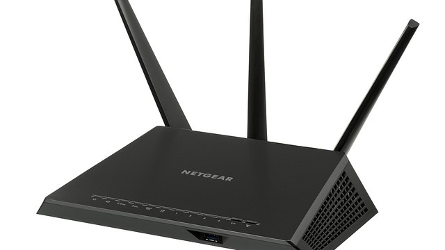 Modern Wi-Fi range extender in a vibrant purple setting.