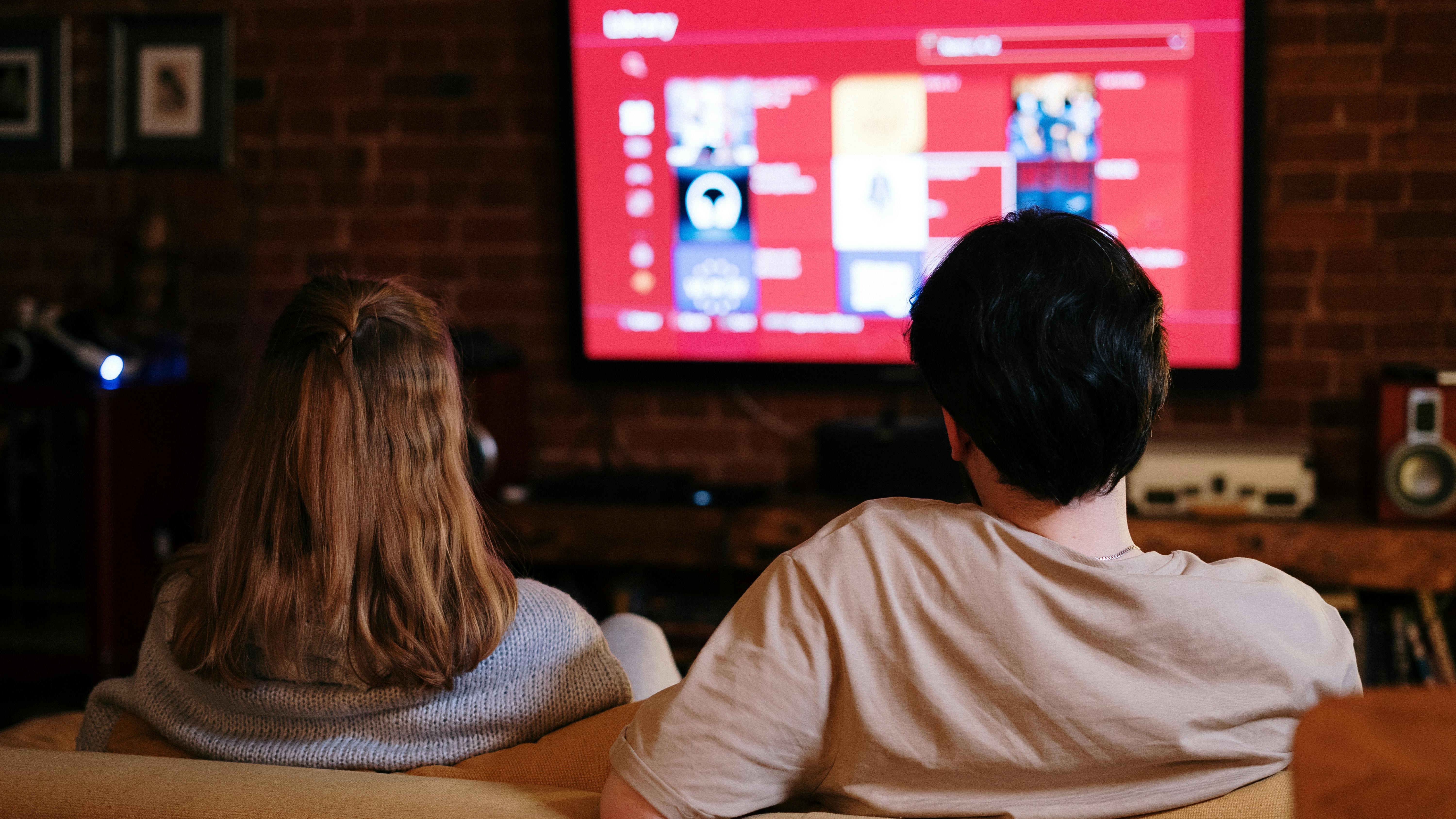 Close-up Ethernet cable connection on smart TV for better streaming.