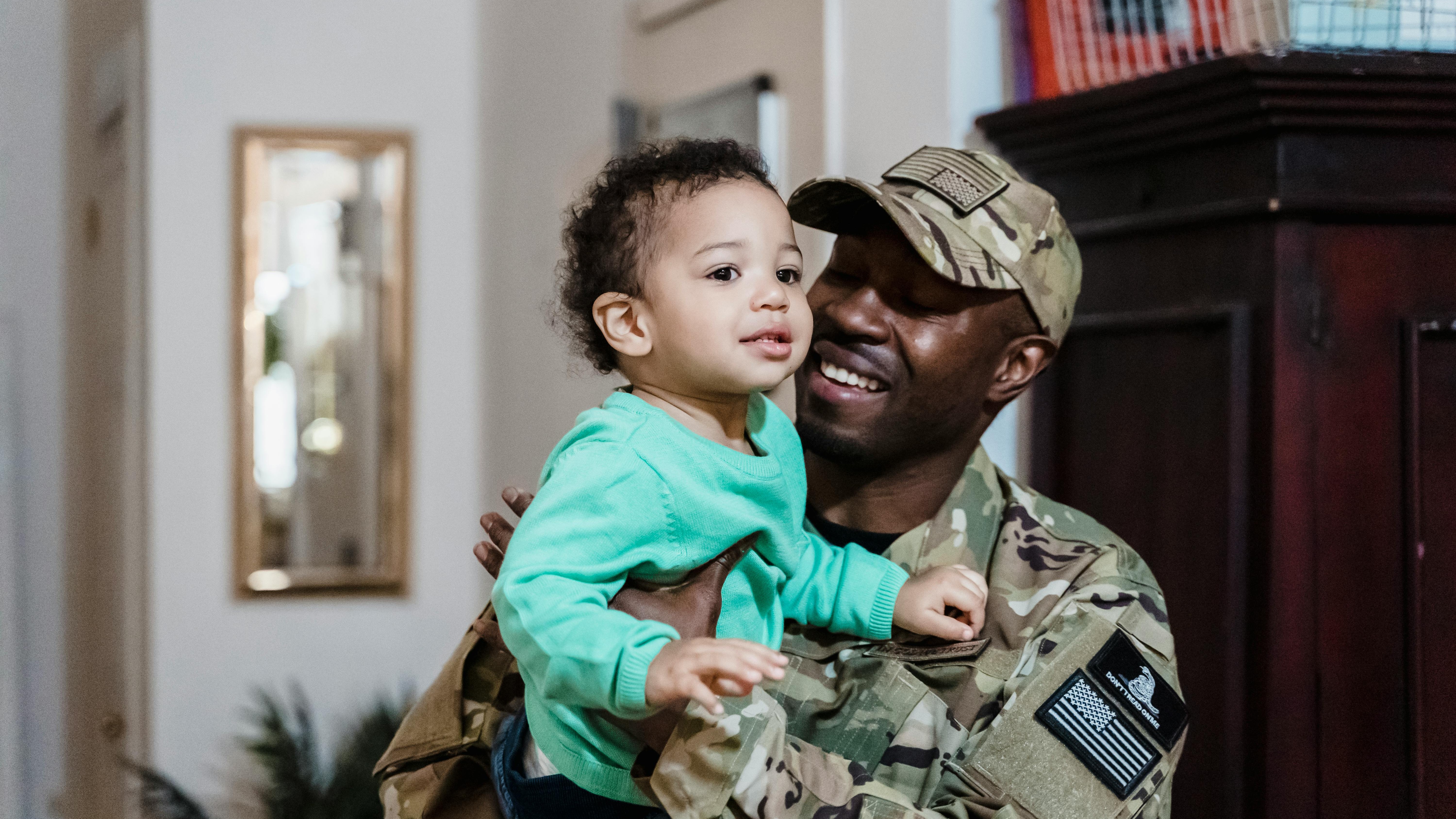 Phishing tactics for military families depicted by a hook and '@' symbols underwater.