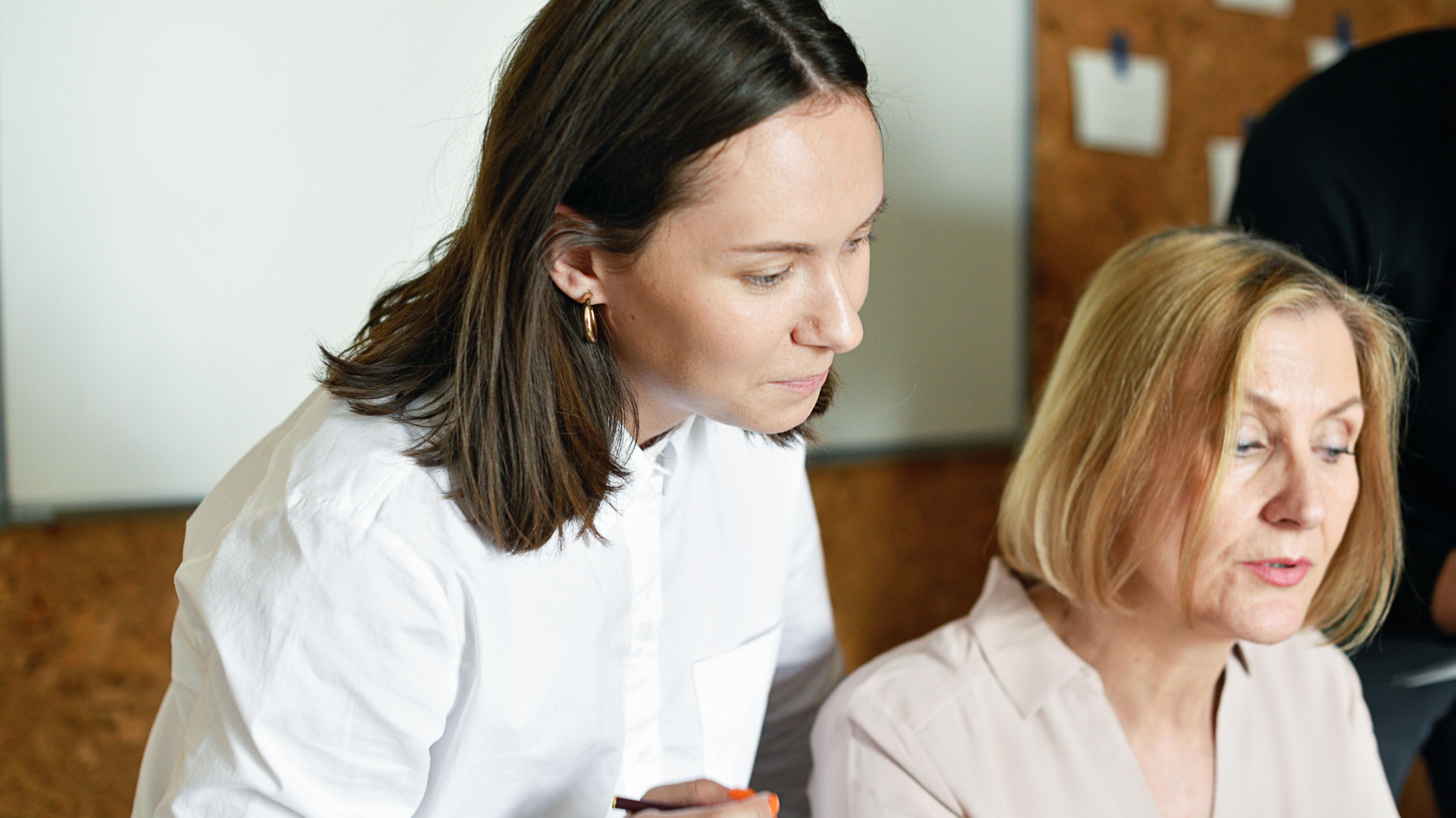 Professionals discussing HR compliance in a modern office space.