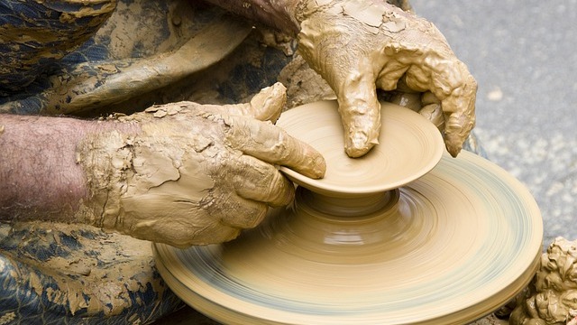 Artisan shaping clay bowl at San Antonio workshop