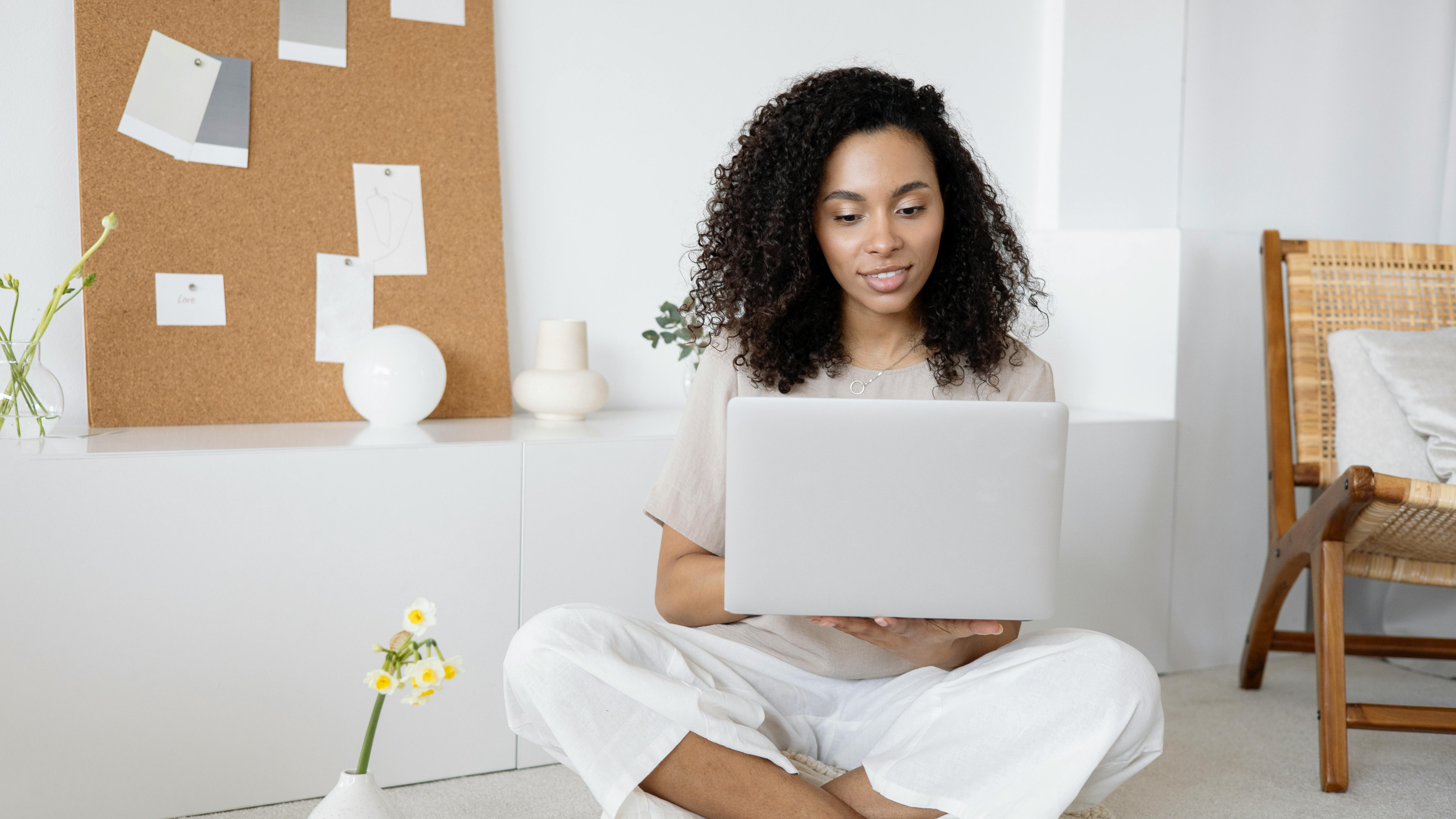 Professional woman smiling in office, highlighting entry-level hiring slowdown.