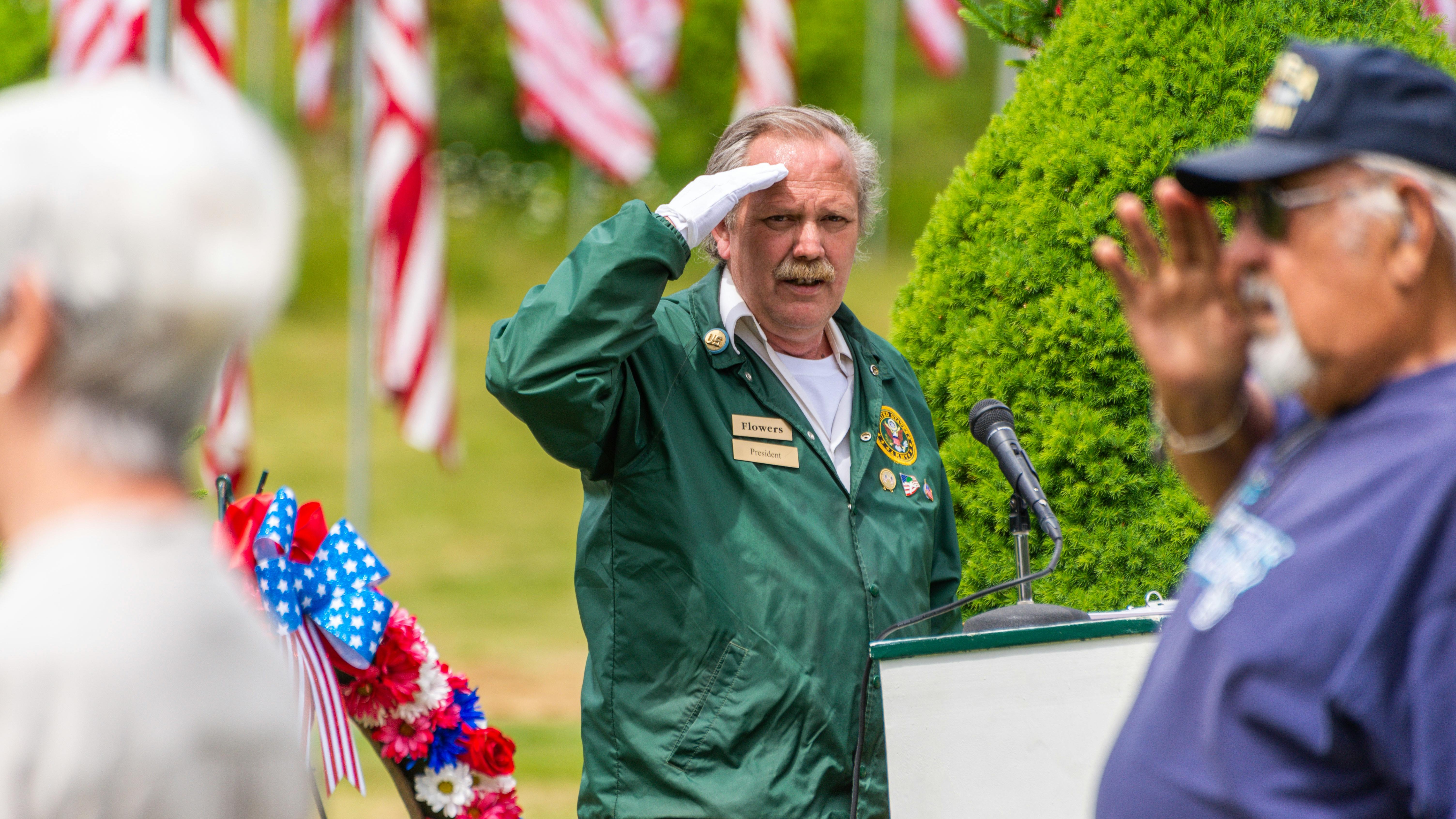 Soldiers in camouflage exhibit military leadership during outdoor ceremony.
