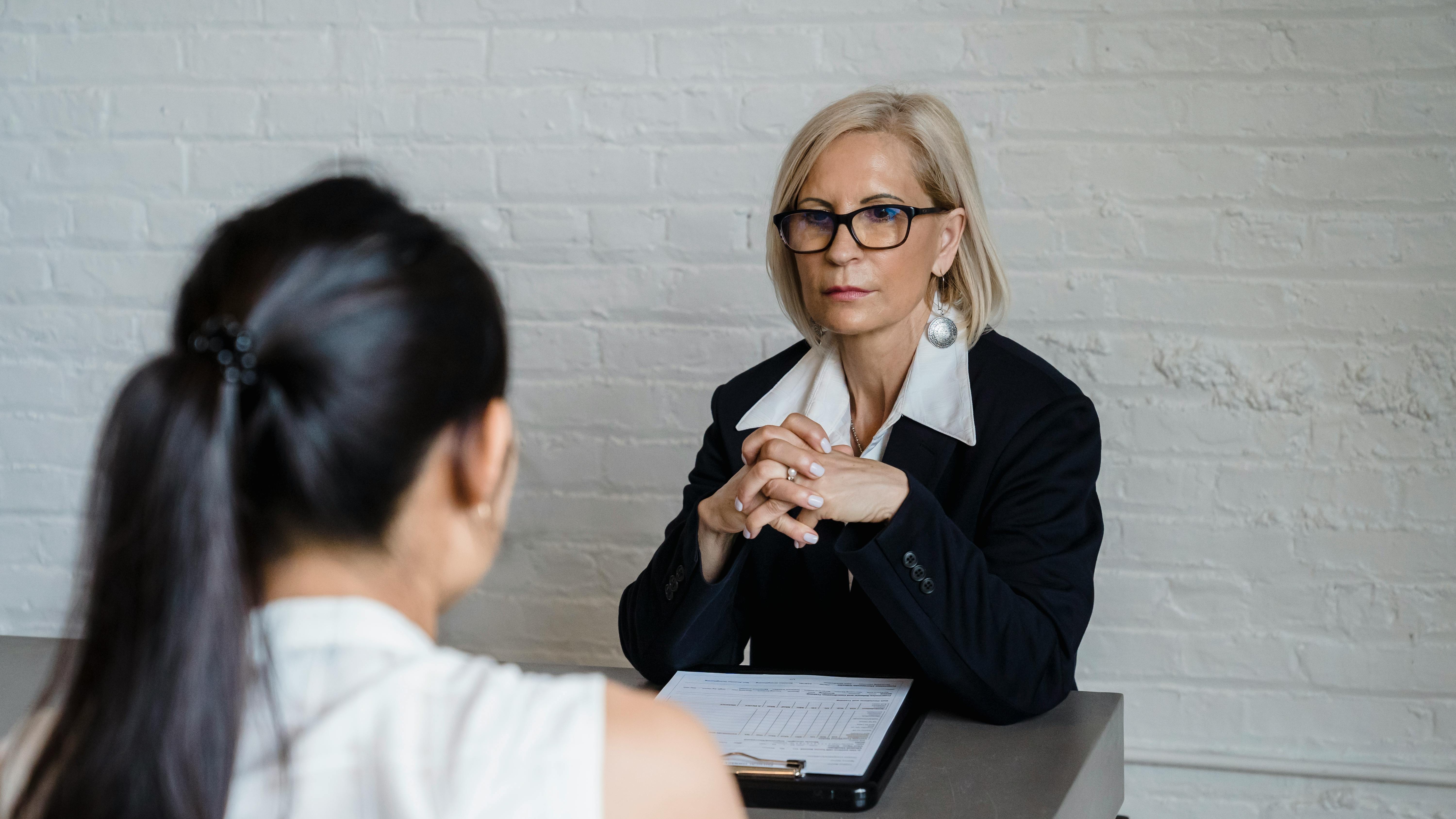 Women in business meeting discussing AI recruiting software in office