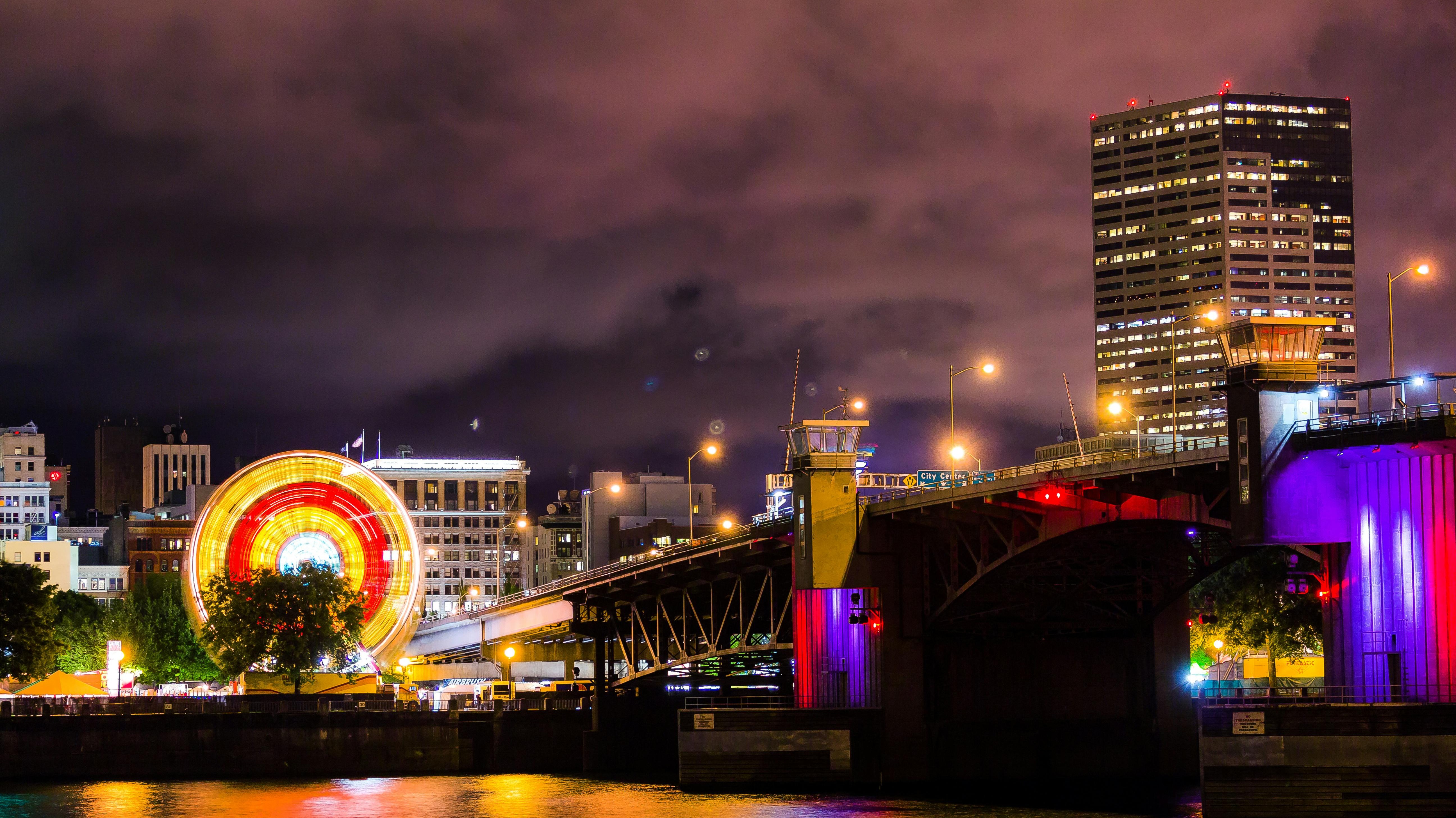 Iconic Portland neon sign with blurred light trails at night.