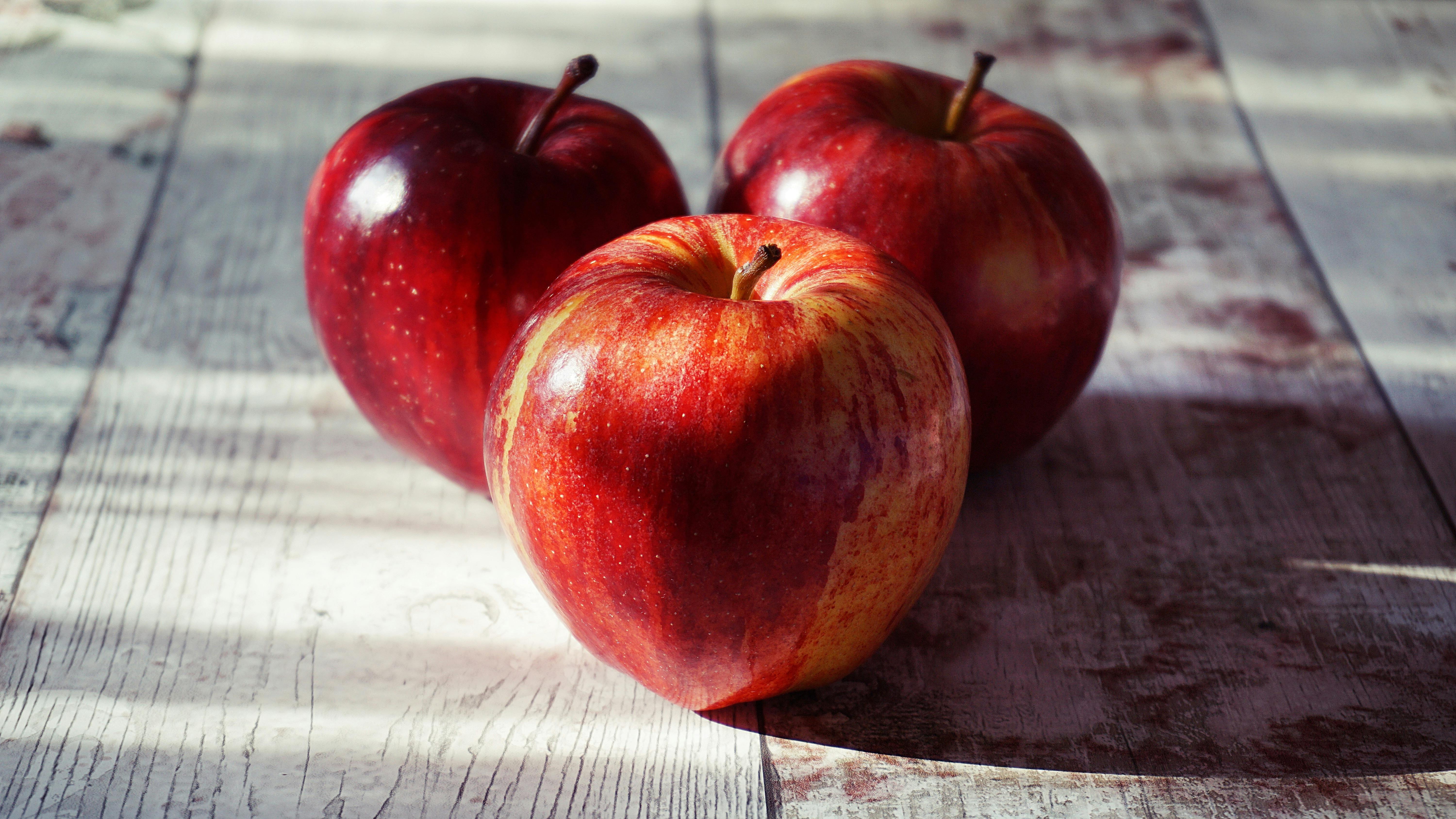 Omaha family life: Hands holding freshly picked apples in an orchard.