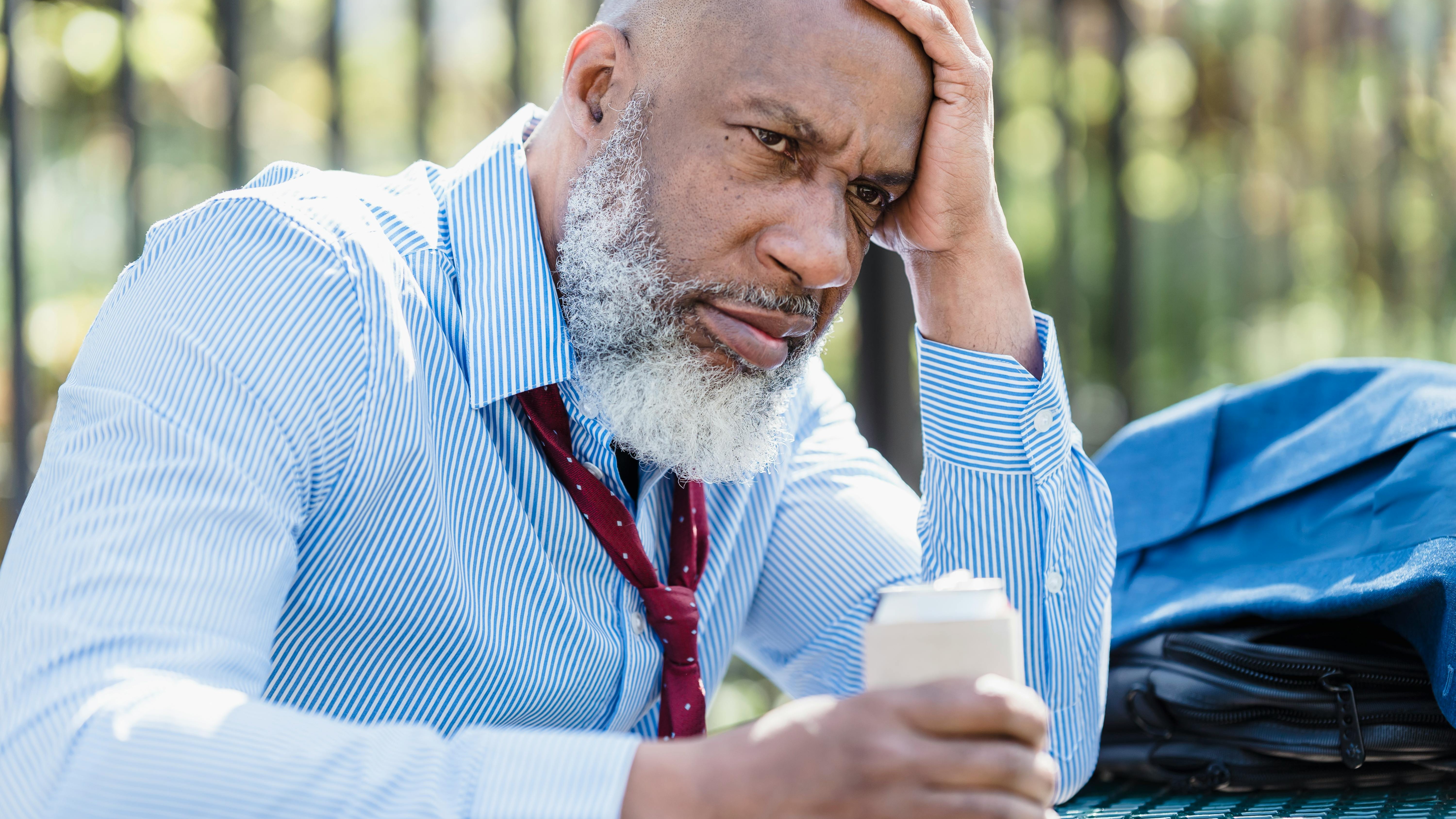 Man in office with papers flying around, illustrating inclusive workplace culture.