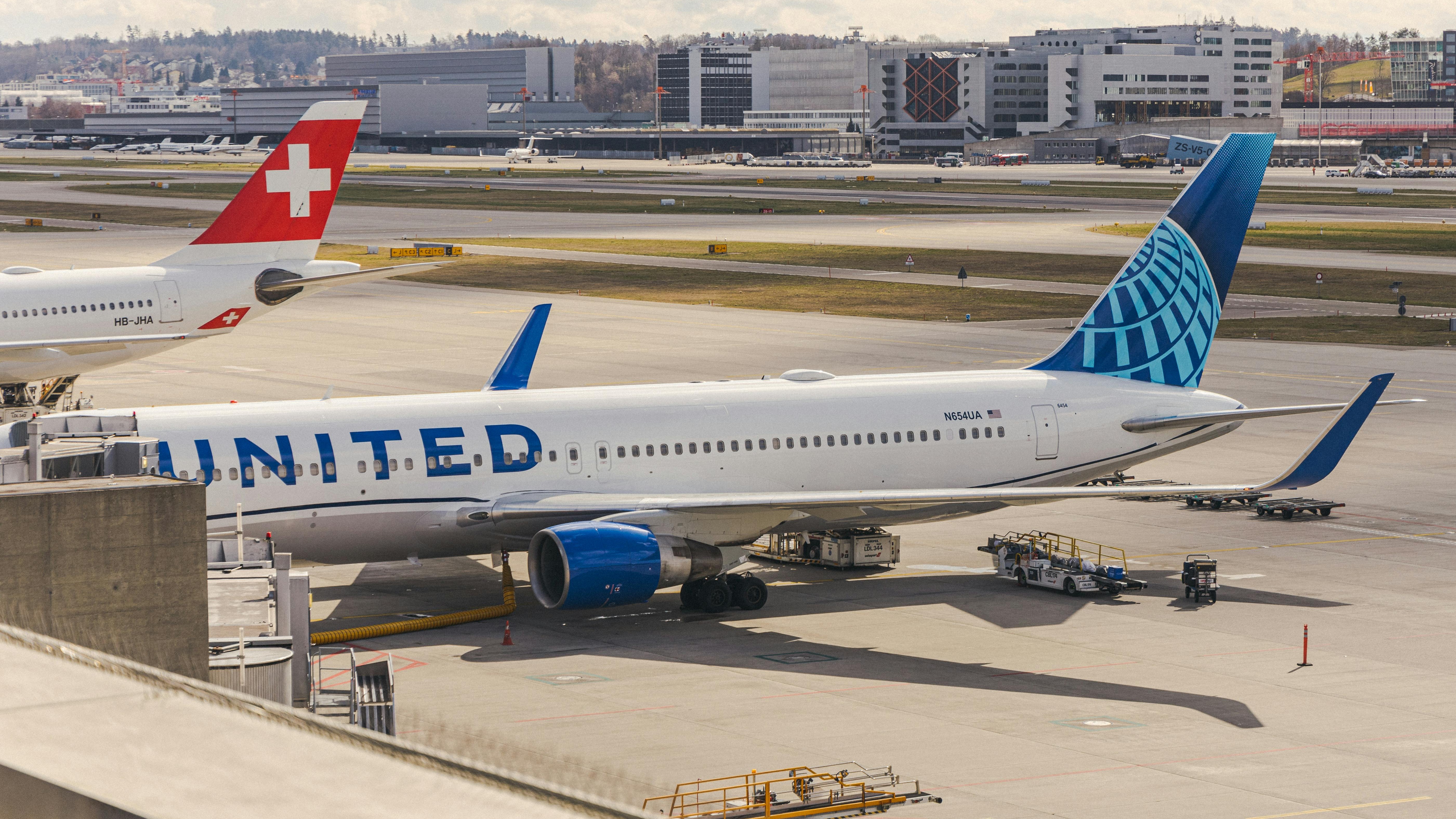 United Airlines Dreamliner flying through clear blue sky.