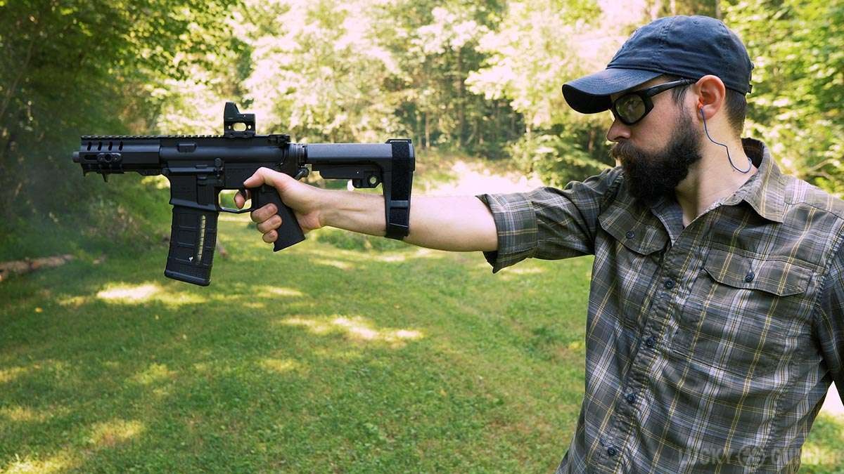 DOJ Pistol Brace Regulations discussion with individuals holding documents.