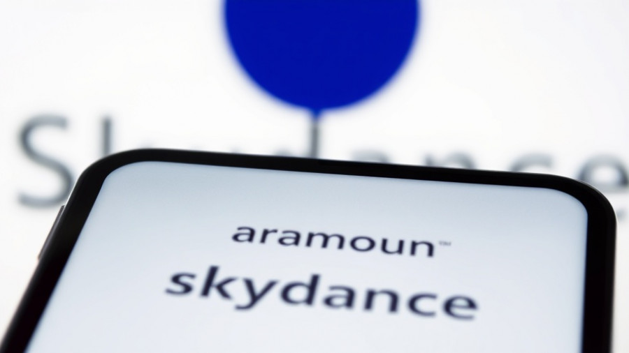 Paramount logo on phone with Skydance text, job cuts context.