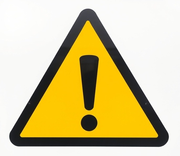 Large triangular warning sign with black exclamation point on yellow background