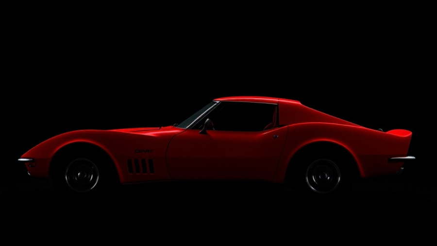 Sleek silhouette of a 1969 Corvette ZL1 in a dark studio.