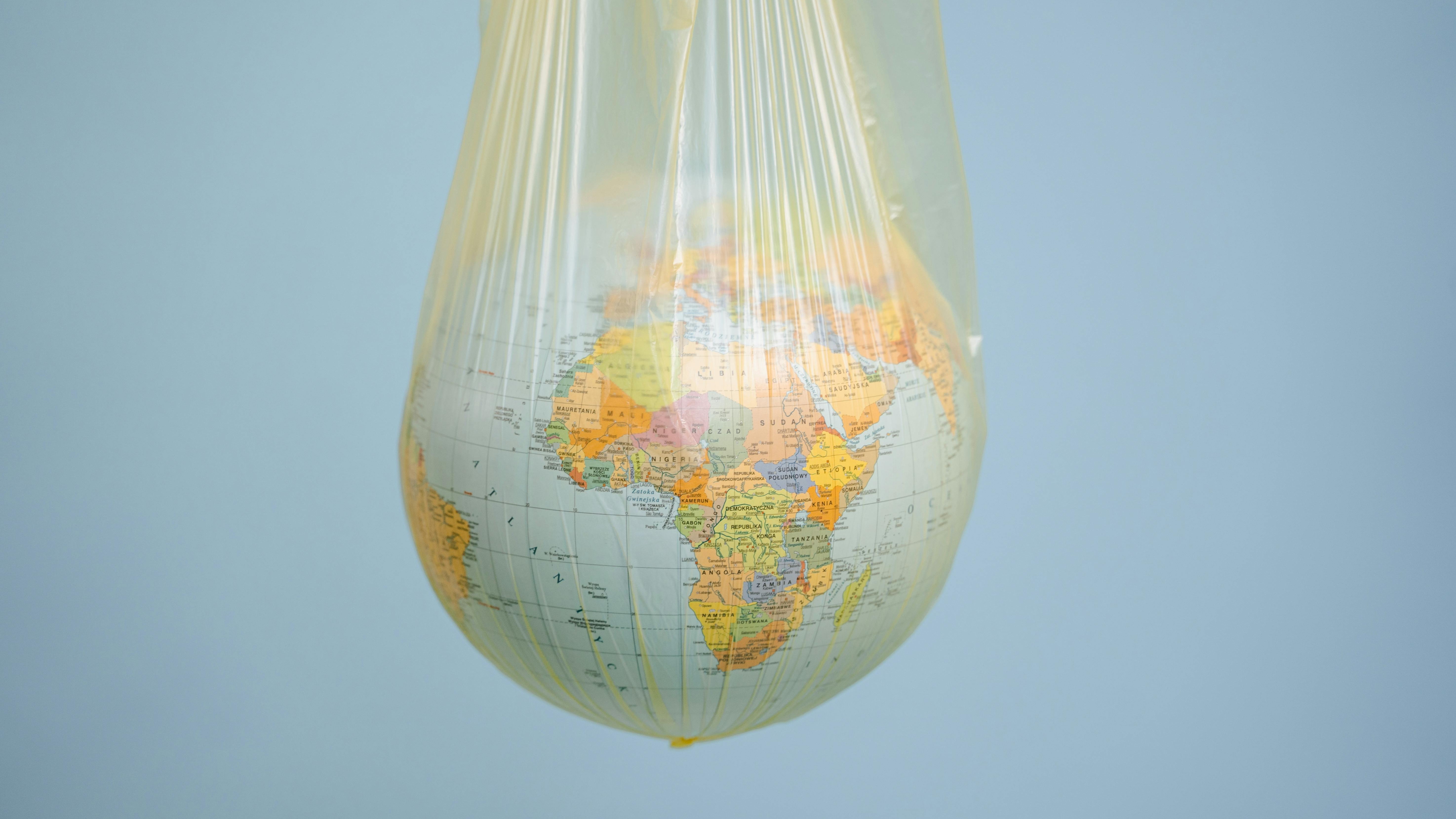 Earth wrapped in plastic; disaster spending impact investment data.