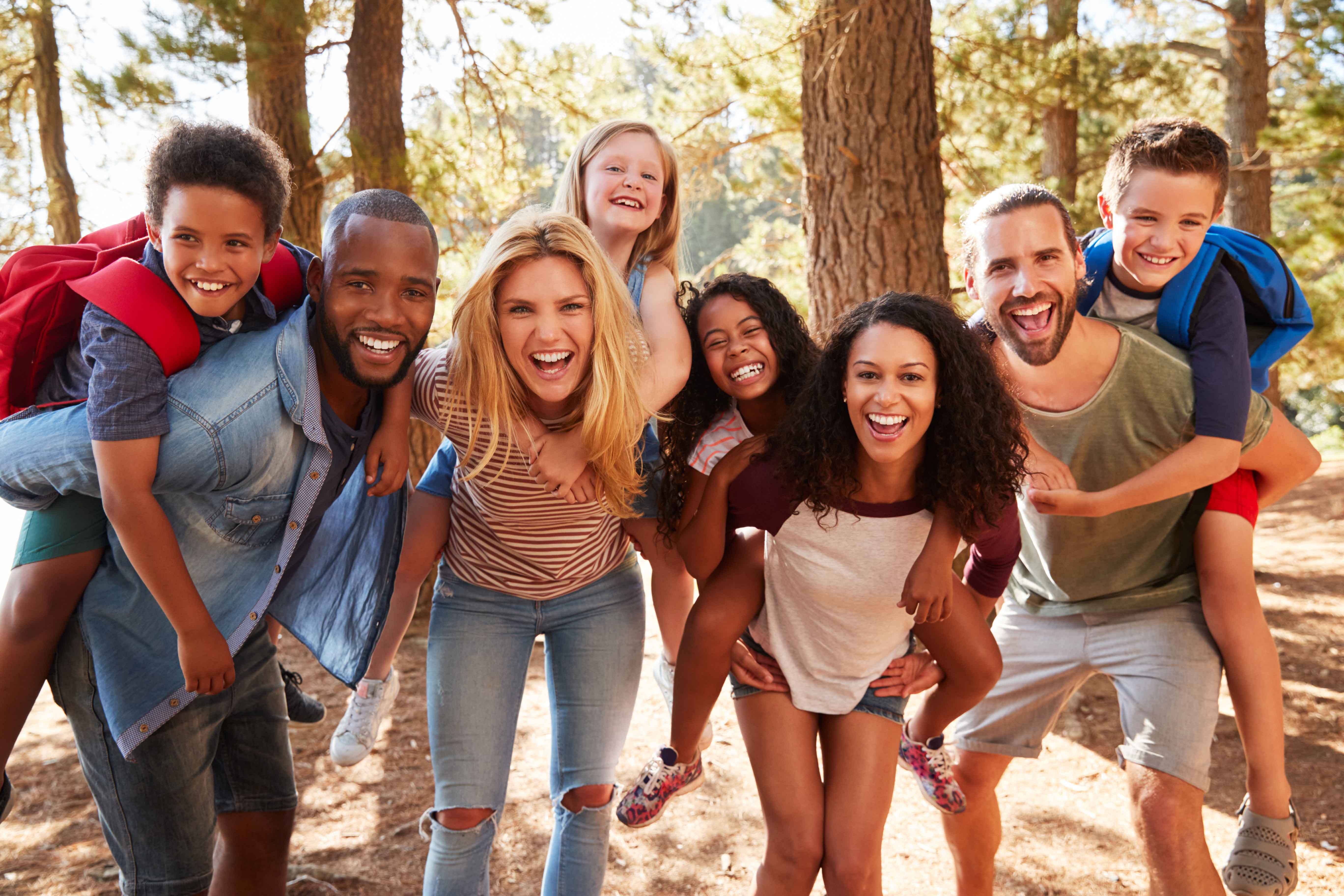 Happy couples & their kids outside enjoying the benefits of the online home business they each have.