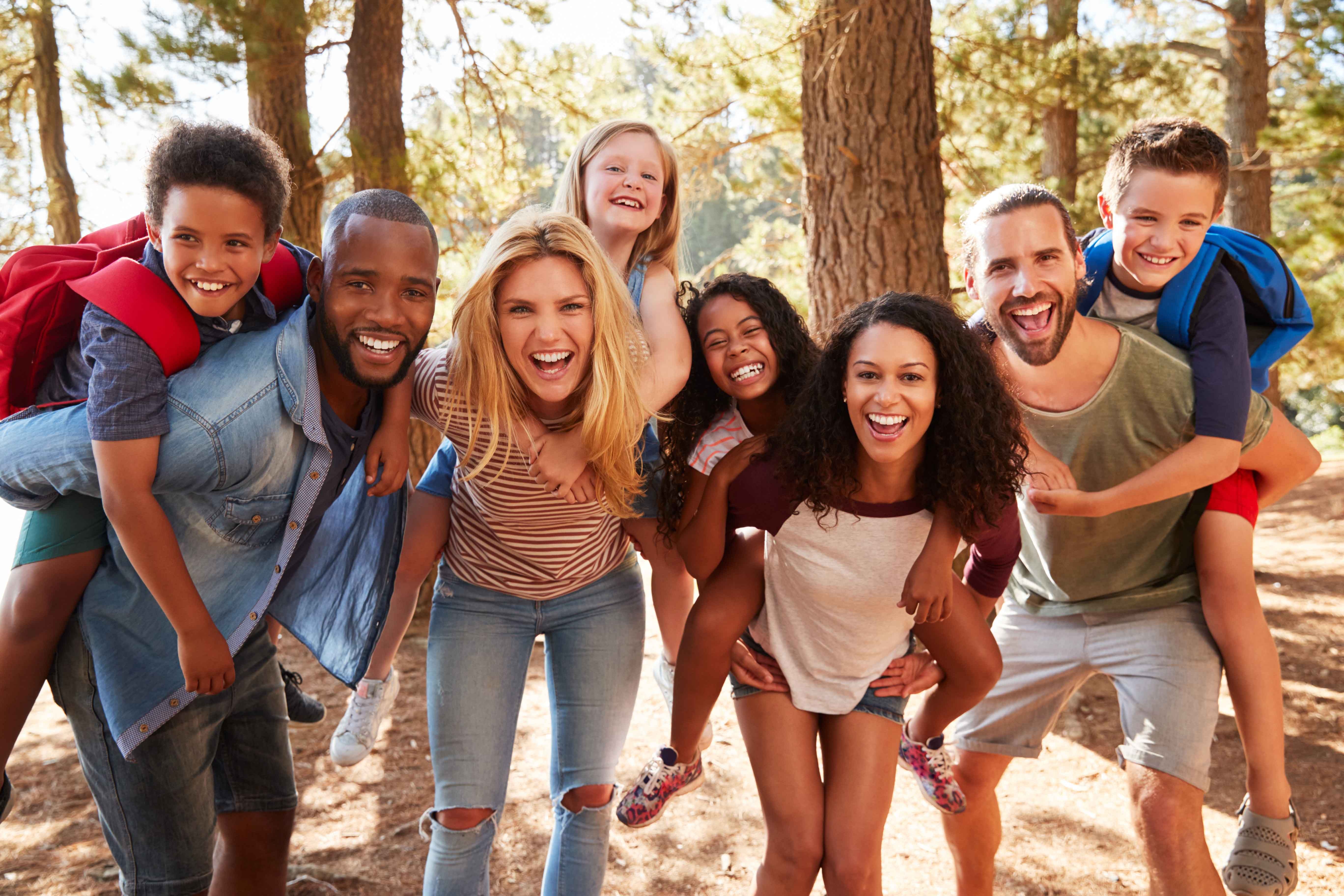 Happy couples & their kids outside enjoying the benefits of the online home business they each have.