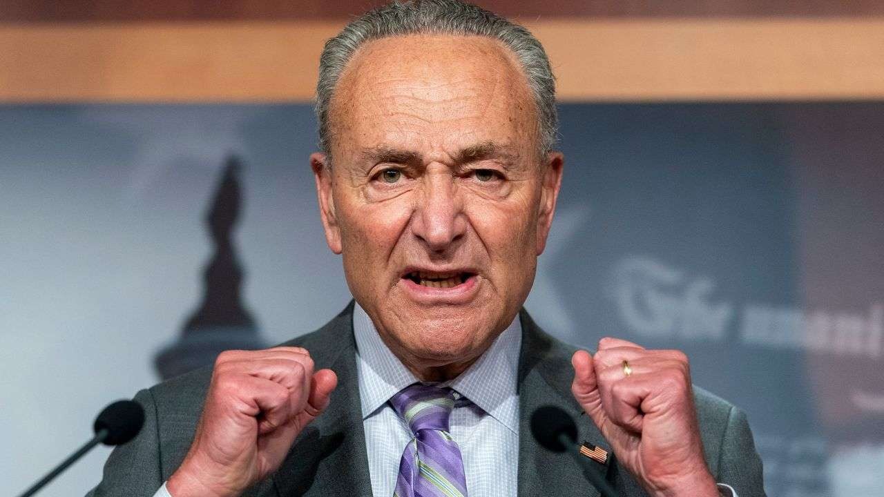 Government shutdown funding fight: man discusses bill in ornate hall.