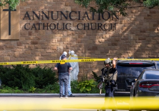 Brick wall of Annunciation Catholic School symbolizing community healing after tragedy.
