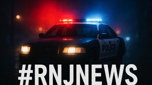 Police car with lights on for New Jersey credit card theft news.