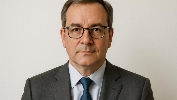 Portrait of the president and CEO of Community Medical Center in a grey suit.