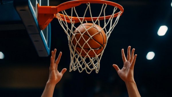 Dynamic basketball hoop action in Hackettstown gym.