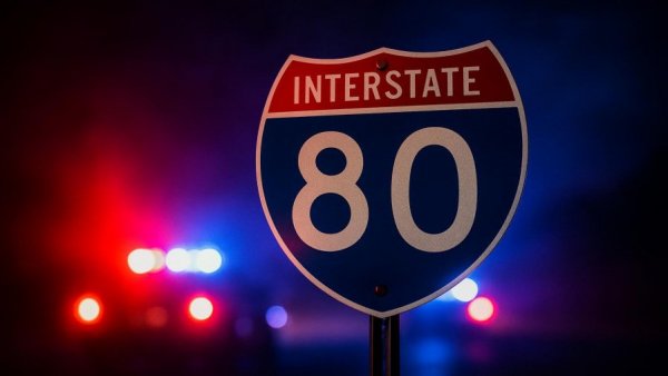 Interstate 80 sign with police lights, symbolizing a multi-vehicle crash in Morris County.