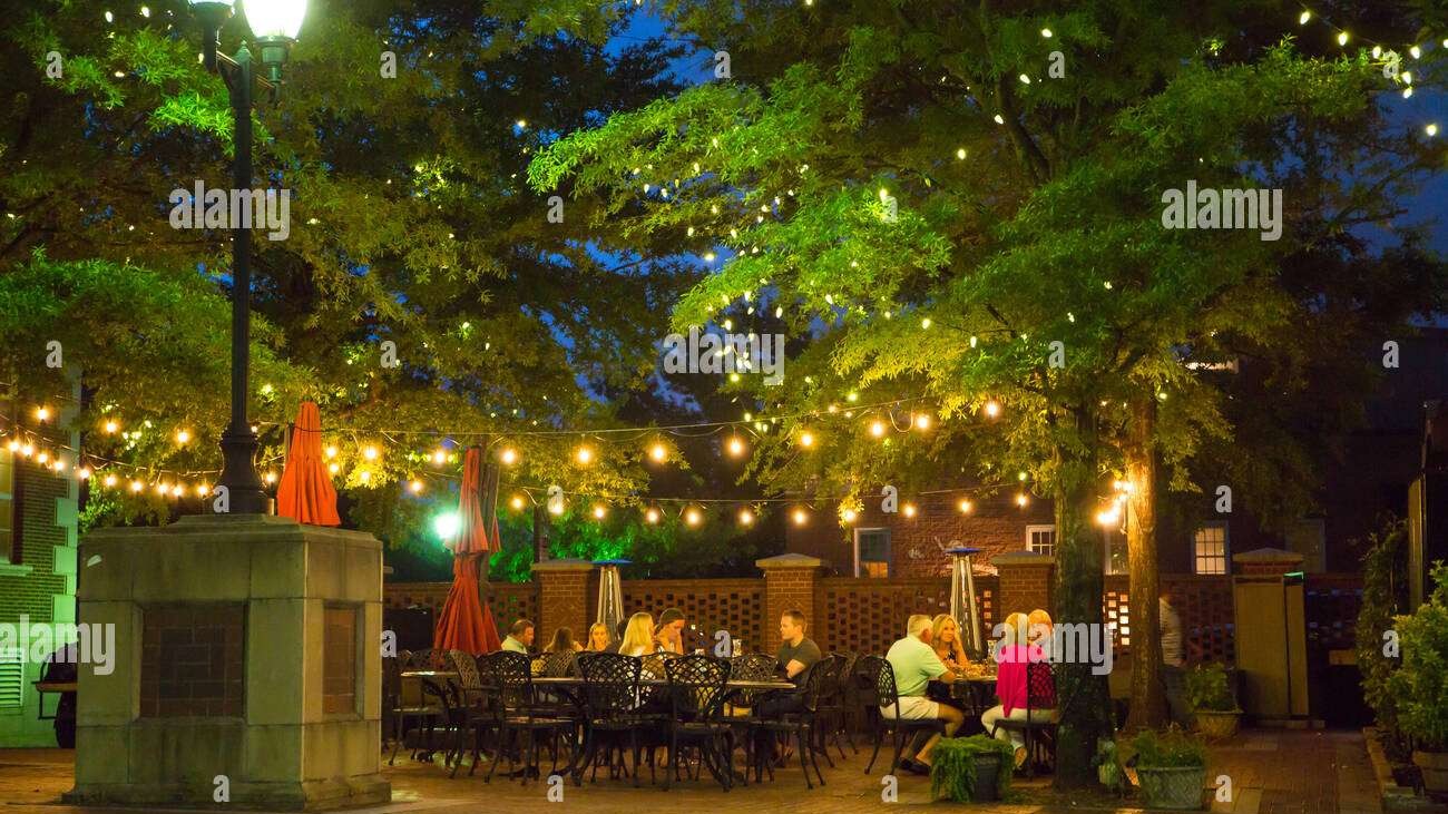 Energetic Greenville SC nightlife scene with colorful street and neon signs.