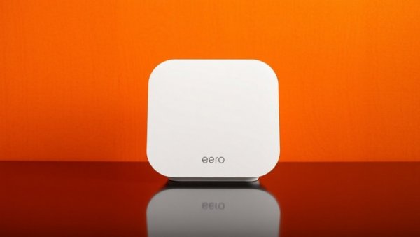 eero Max 7 mesh Wi-Fi router against a vibrant orange background.