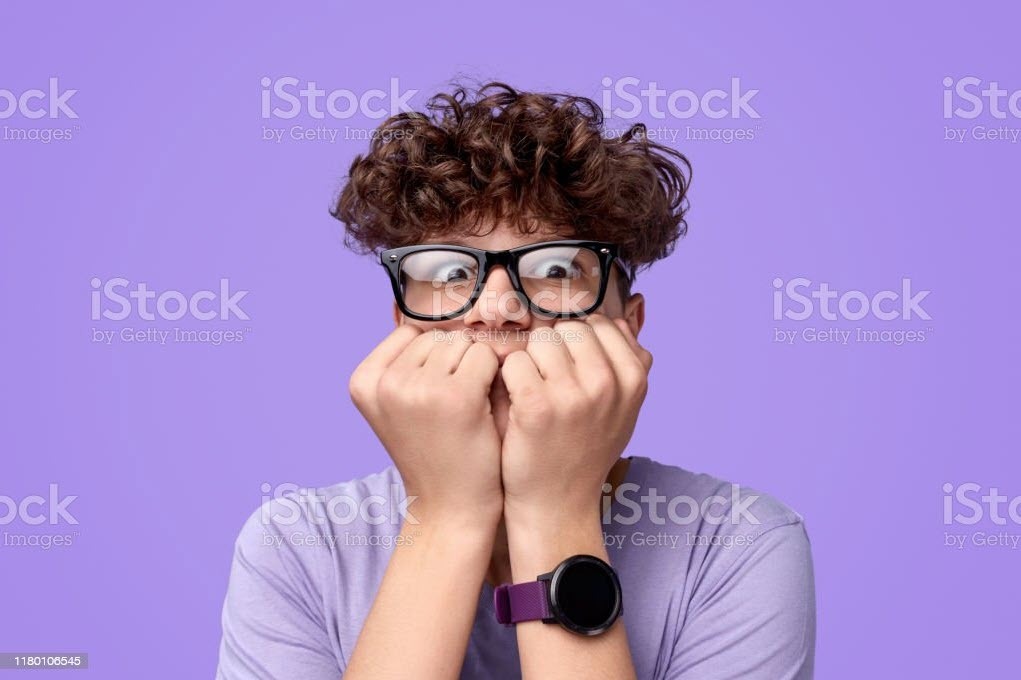 Anxiety in the face of a male biting his nails