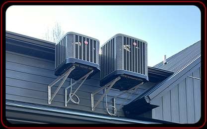 Two AC units installed on upper wall of building just under the roof edge Central Kentucky