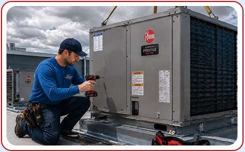 Technician installing commercial Heat Pump on rooftop of building Central Kentucky