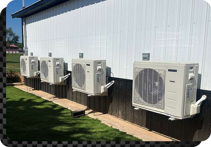 Four HVAC units newly installed on the side of a commercial building by Anderson Heating and Cooling in Central Kentucky