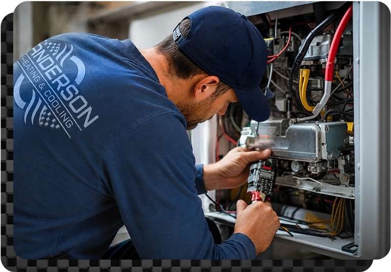 Technician doing a service repair on furnace in residential home central Kentucky