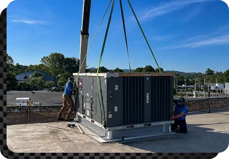 Anderson Heating and Cooling technicians installing a commercial HVAC on building rooftop in Central Kentucky