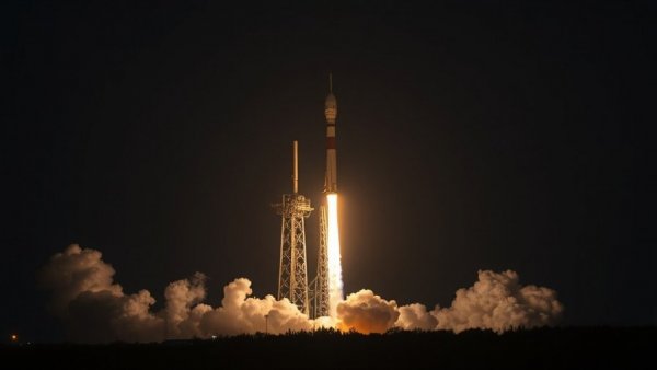 SpaceX 100th launch nighttime rocket liftoff with dramatic lighting.